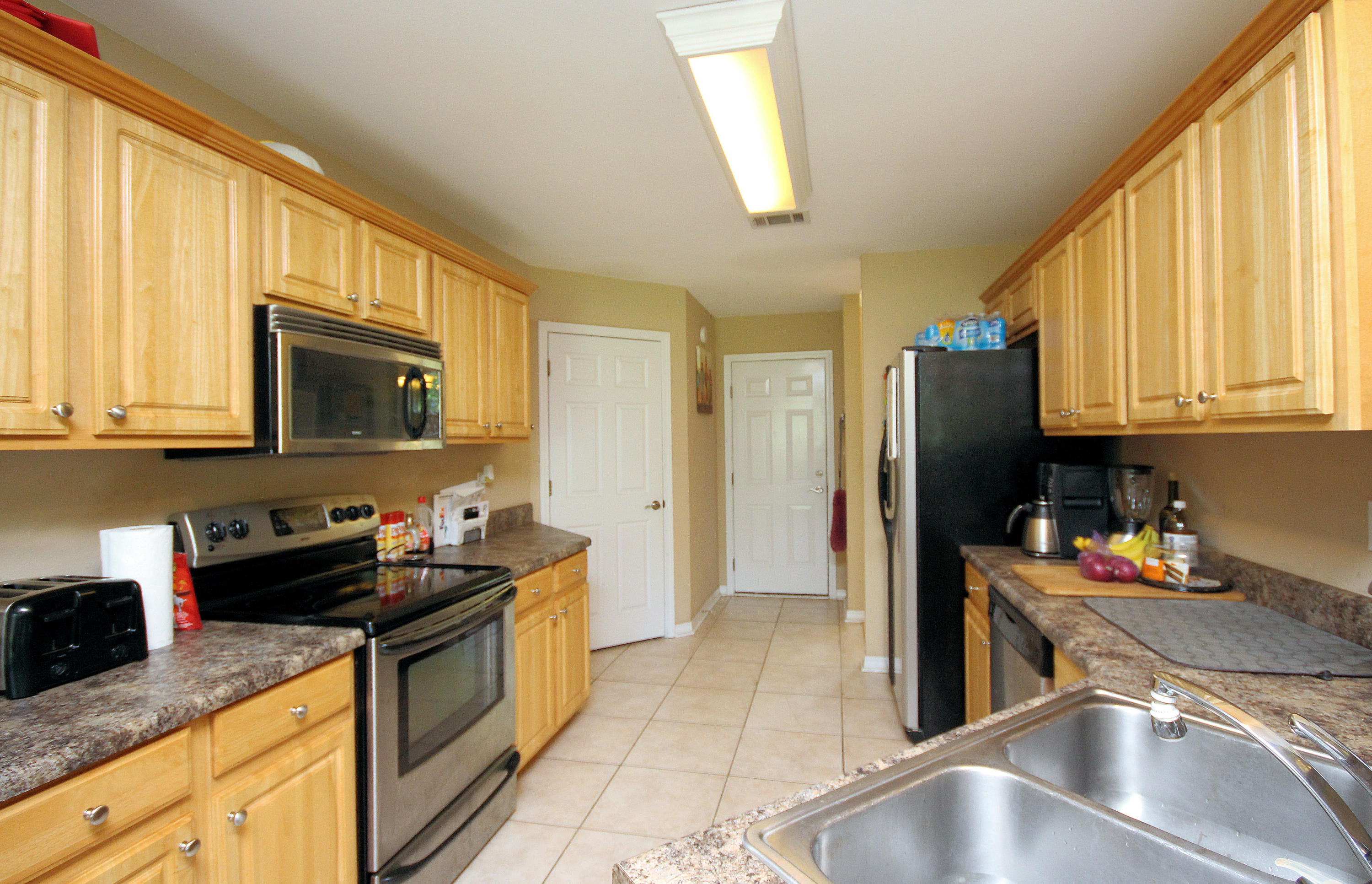 5819 Roberts Road Crestview, FL 32536 - Photo 8 of 36 a kitchen with stainless steel appliances granite countertop a sink stove and refrigerator