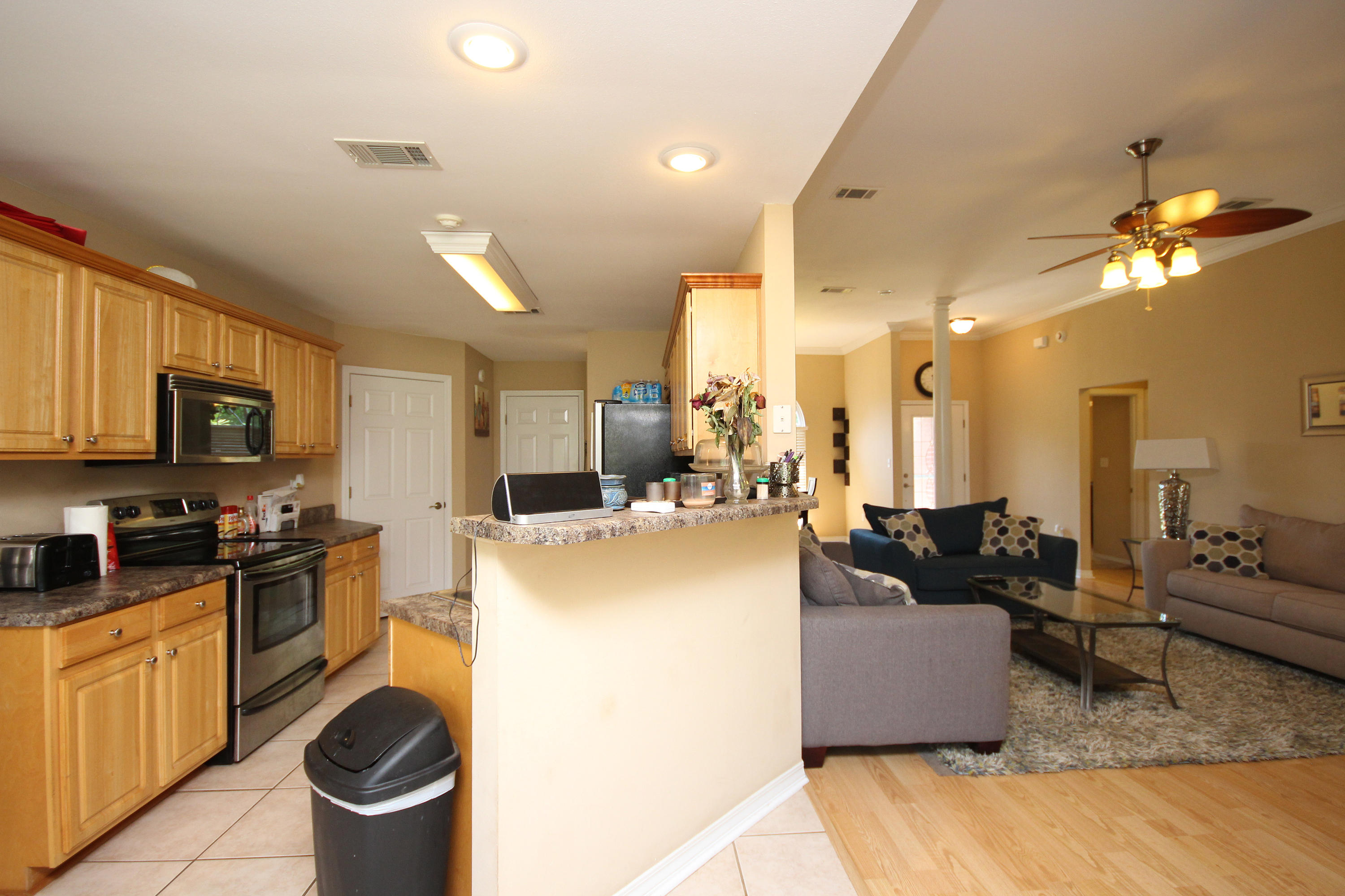 5819 Roberts Road Crestview, FL 32536 - Photo 10 of 36 a living room with furniture a flat screen tv and kitchen view