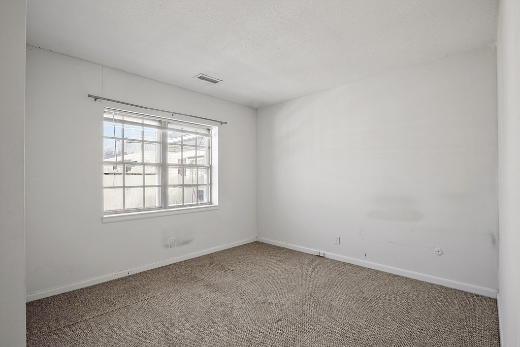 170 Lake Shore Road, Unit 4 Boston, MA 02135 - Photo 16 of 36 an empty room with a window