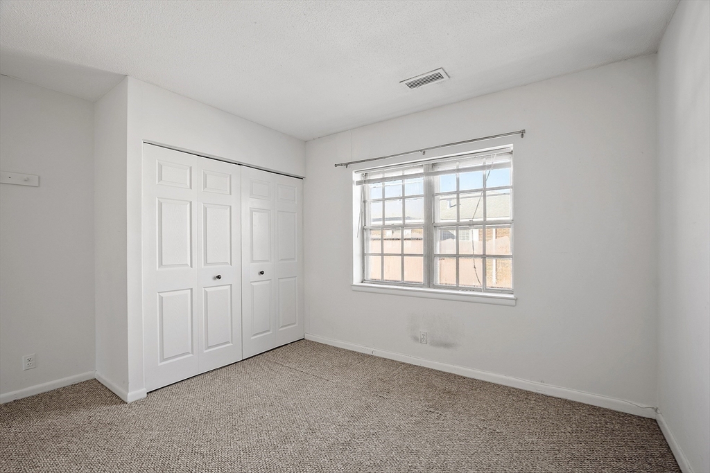 170 Lake Shore Road, Unit 4 Boston, MA 02135 - Photo 17 of 36 a view of an empty room with a window