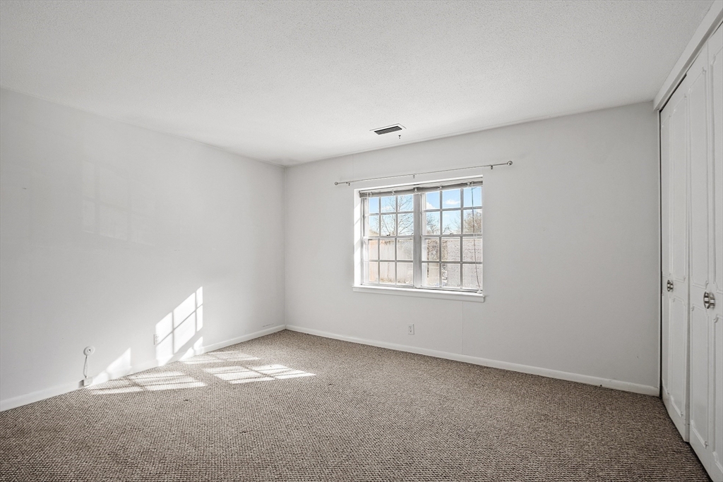 170 Lake Shore Road, Unit 4 Boston, MA 02135 - Photo 21 of 36 an empty room with a window