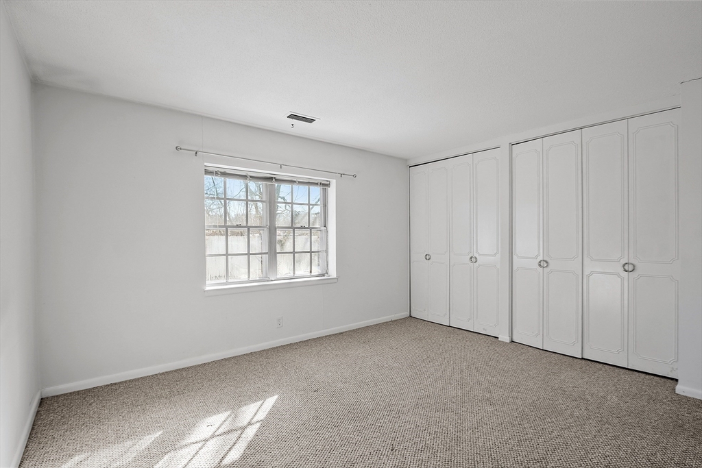 170 Lake Shore Road, Unit 4 Boston, MA 02135 - Photo 25 of 36 a view of an empty room with a window