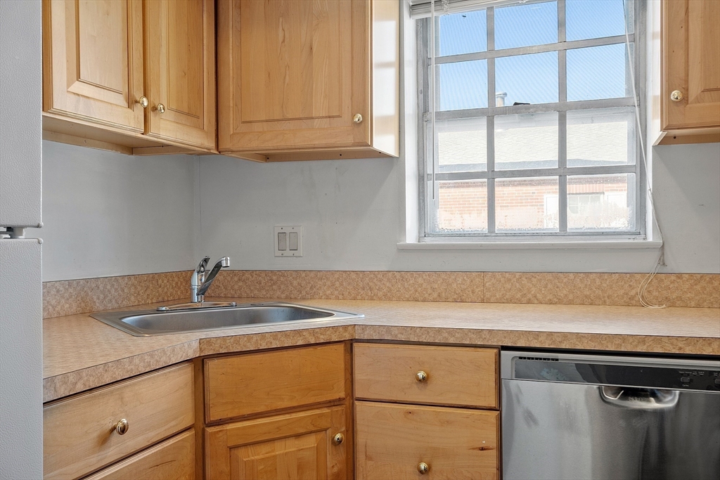170 Lake Shore Road, Unit 4 Boston, MA 02135 - Photo 6 of 36 a kitchen with granite countertop cabinets and window