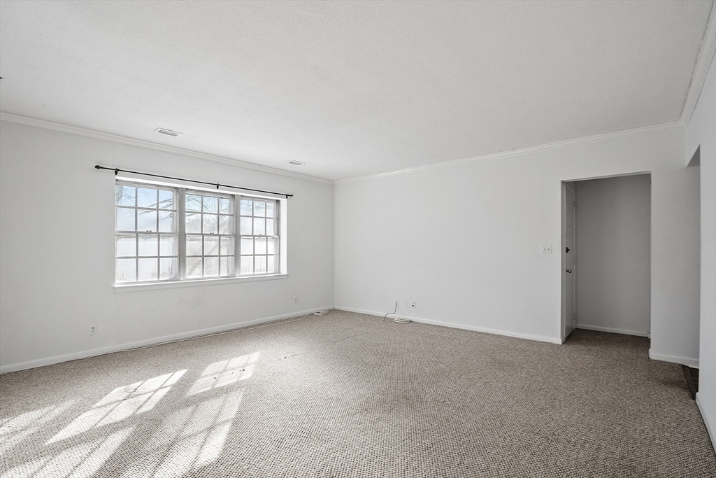 170 Lake Shore Road, Unit 4 Boston, MA 02135 - Photo 10 of 36 a view of an empty room with a window