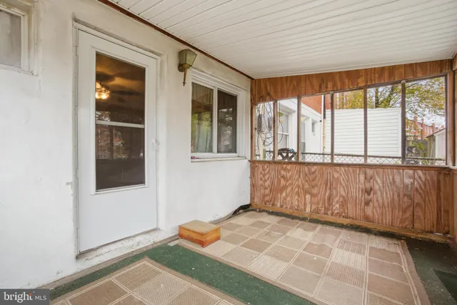 a view of a brick house with a yard in the background
