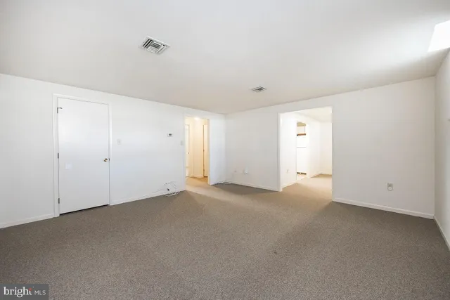 an empty room with a empty space and windows