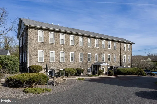 a front view of building with yard and green space