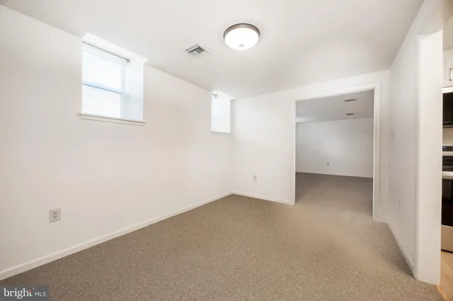 a view of an empty room with a window