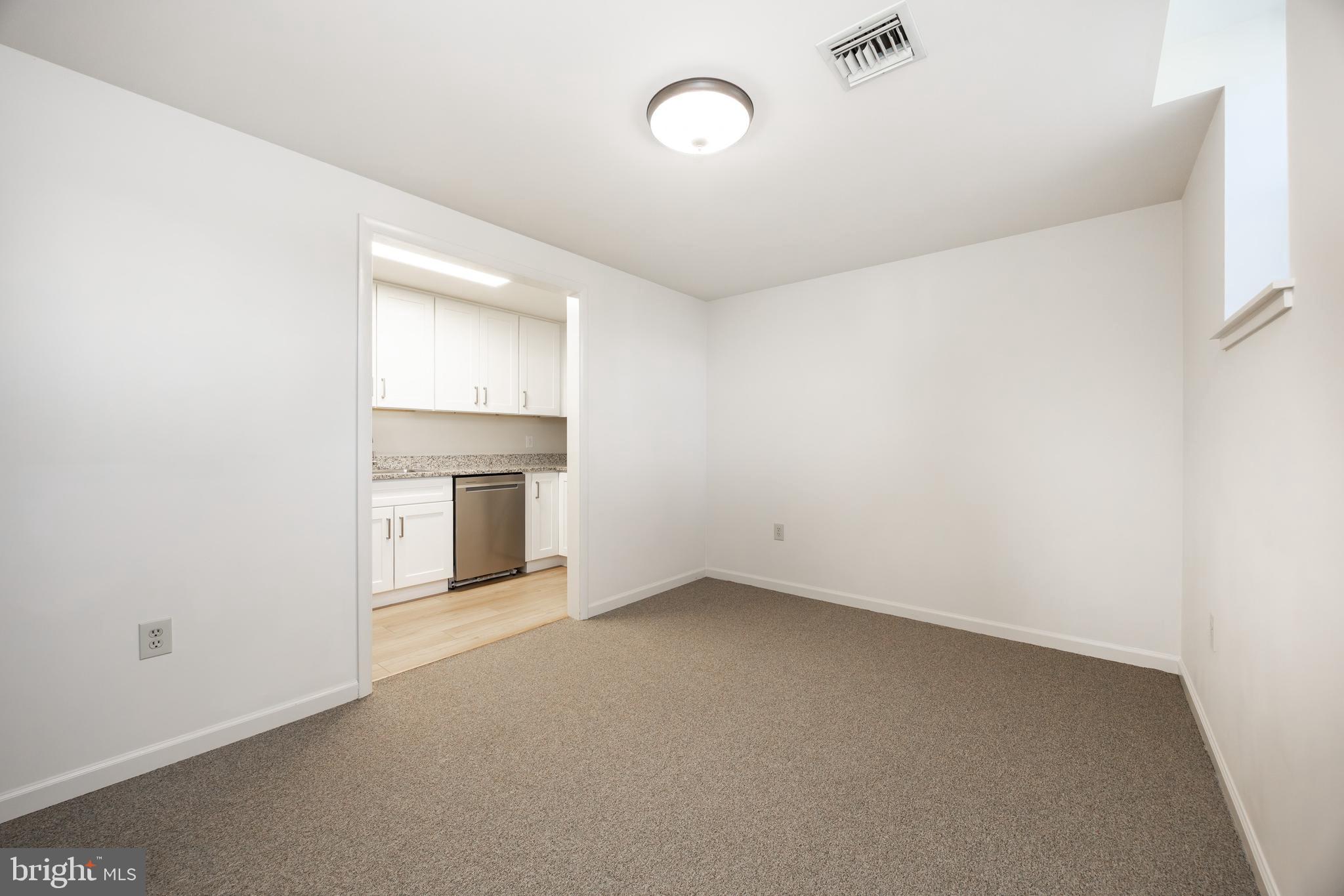 3183 Main Street, Unit 3 Green Lane, PA 18054 - Photo 10 of 28 an empty room with a fireplace and cabinet