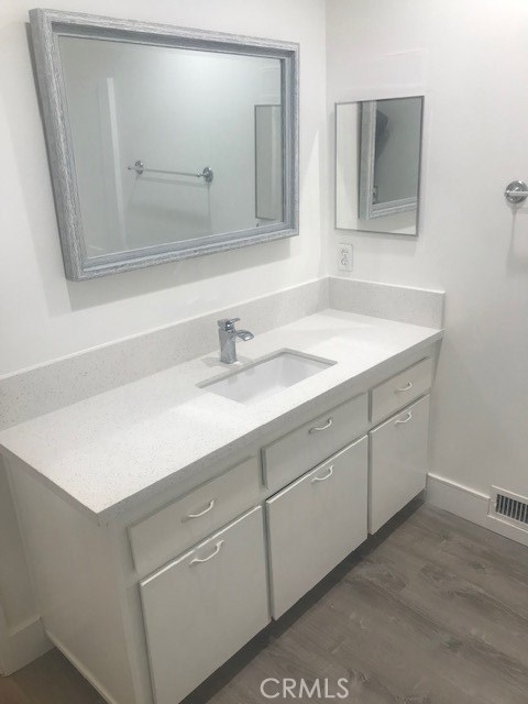 2155 Canyon Drive, Unit A Costa Mesa, CA 92627 - Photo 5 of 10 a bathroom with a sink and a mirror