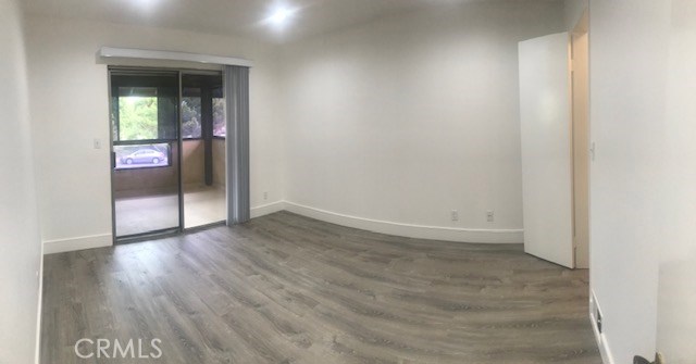 2155 Canyon Drive, Unit A Costa Mesa, CA 92627 - Photo 7 of 10 an empty room with wooden floor and entrance