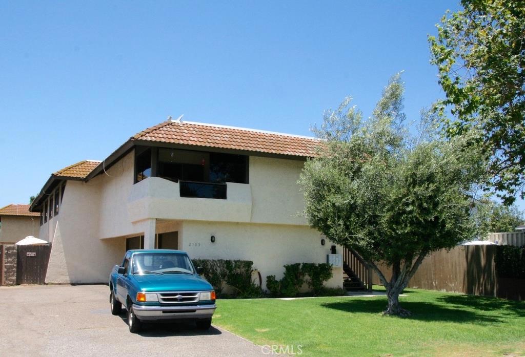 2155 Canyon Drive, Unit A Costa Mesa, CA 92627 - Photo 10 of 10 a car parked in front of white house