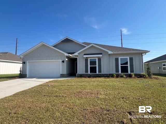 24132 Rieger Drive Elberta, AL 36530 - Photo 1 of 21 View of front of home with board and batten siding, an attached garage, concrete driveway, and a front lawn