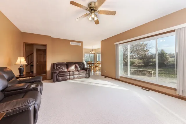 a spacious bedroom with a bed couch and a large window