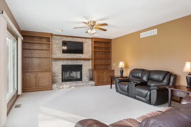 a living room with a fireplace and a flat screen tv