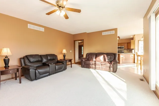 a view of a livingroom with furniture and a large window