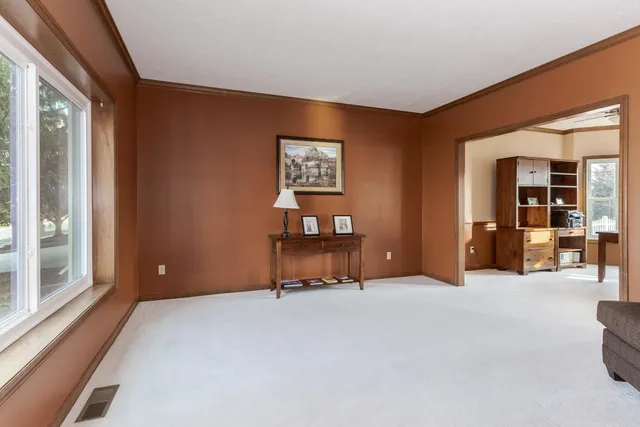 a view of a workspace with furniture and a window