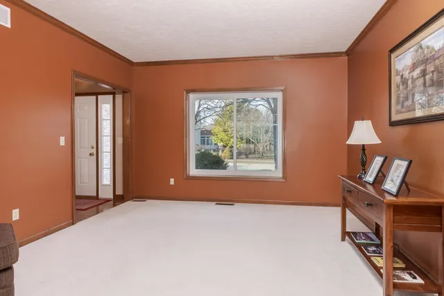 a kitchen with stainless steel appliances kitchen island granite countertop a stove top oven a sink a dining table and chairs with the view of kitchen