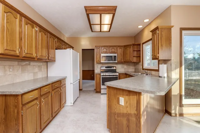 a view of a dining room with furniture large windows and wooden floor