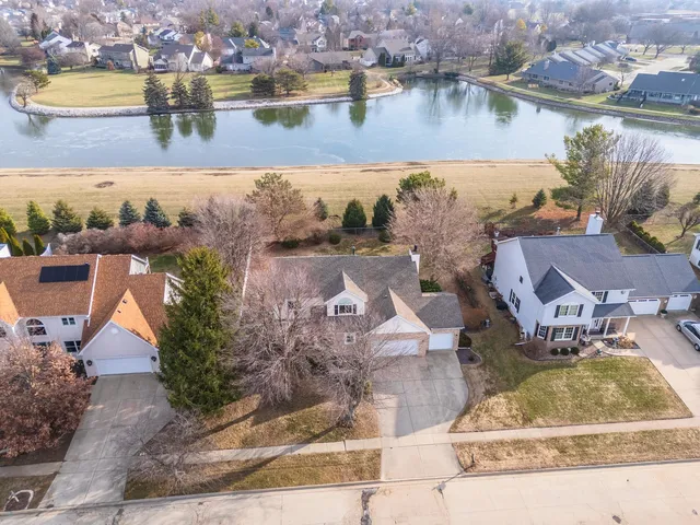 an aerial view of residential houses with outdoor space and ocean view