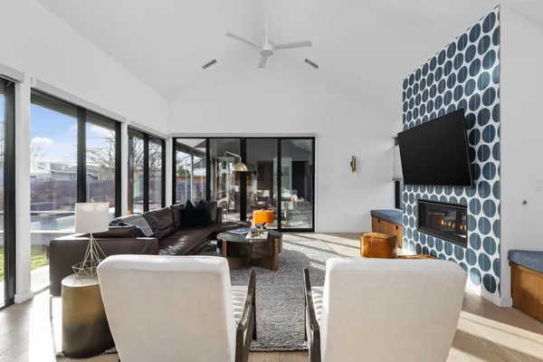 a living room with furniture and large windows