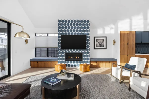 a living room with furniture a flat screen tv and a large window