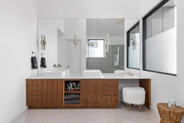 a bathroom with a double vanity sink and a mirror