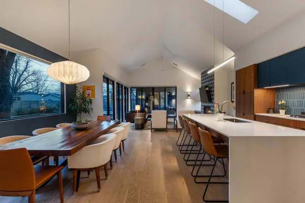 a kitchen with stainless steel appliances a table and chairs
