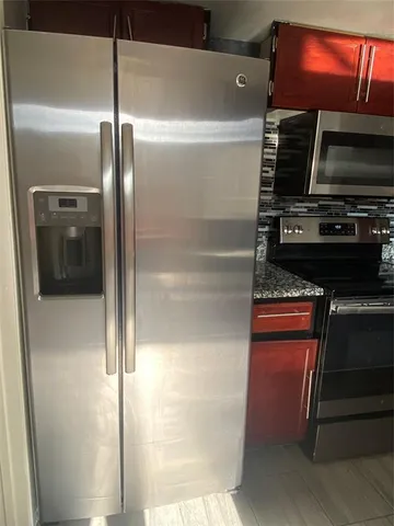 a kitchen with a refrigerator and a microwave