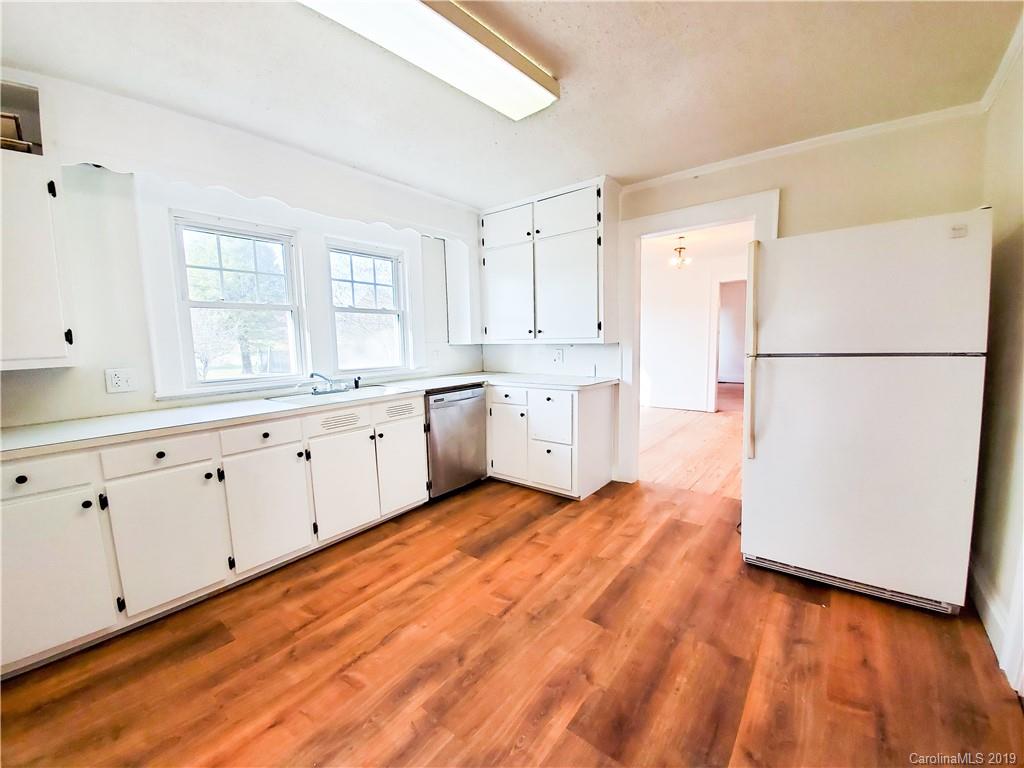 7405 Houser Farm Road Vale, NC 28168 - Photo 14 of 28 a kitchen with white cabinets and white appliances