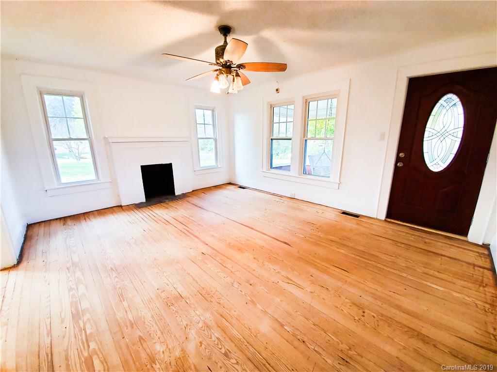 7405 Houser Farm Road Vale, NC 28168 - Photo 8 of 28 a view of empty room with wooden floor and fan
