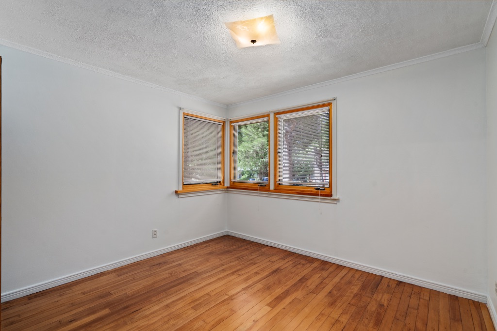 1212 Bentwood Road Austin, TX 78722 - Photo 15 of 32 a view of an empty room with wooden floor and a window