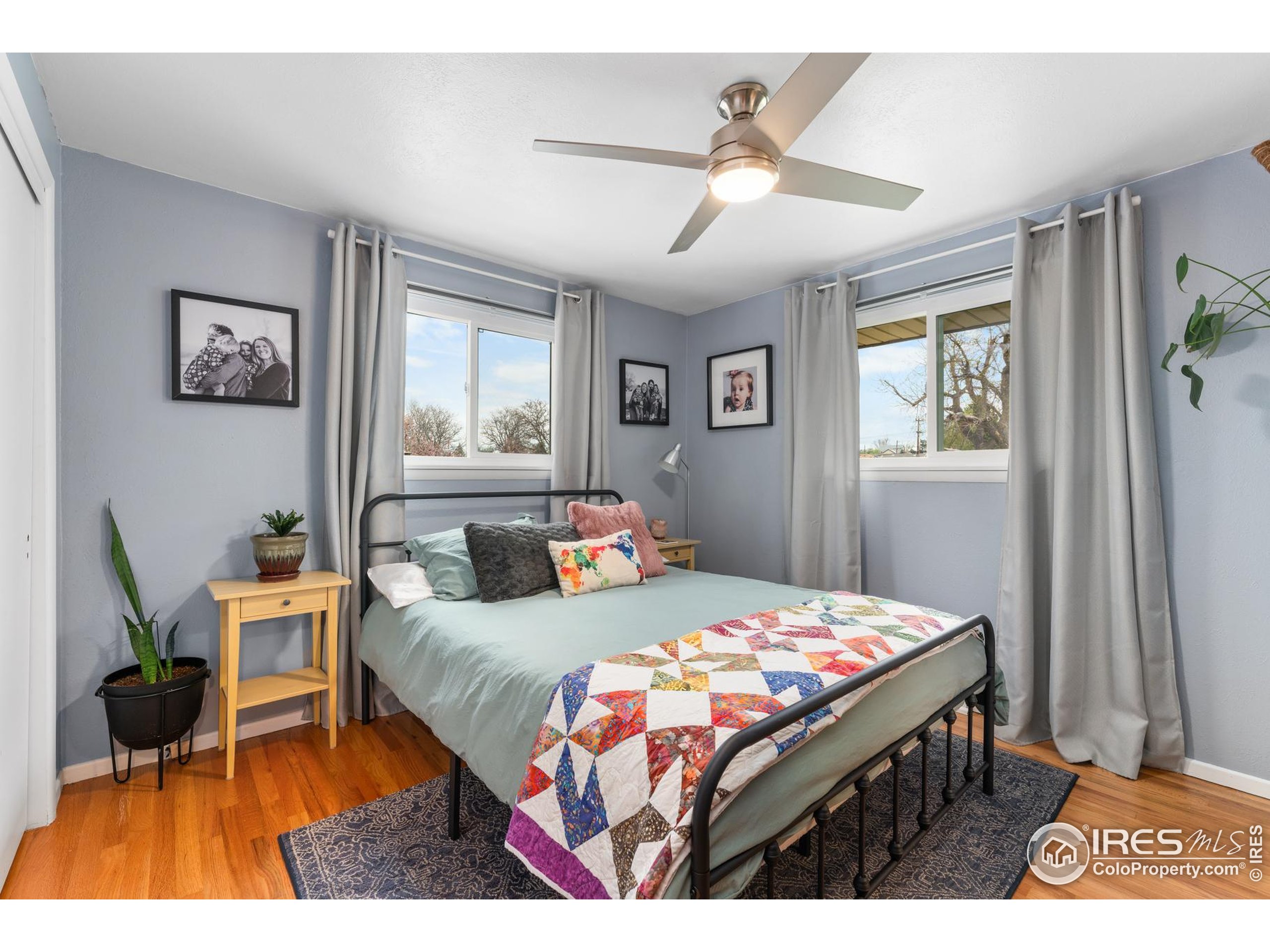 9261 Julian Way Westminster, CO 80031 - Photo 14 of 33 a bedroom with a bed a rug and a window