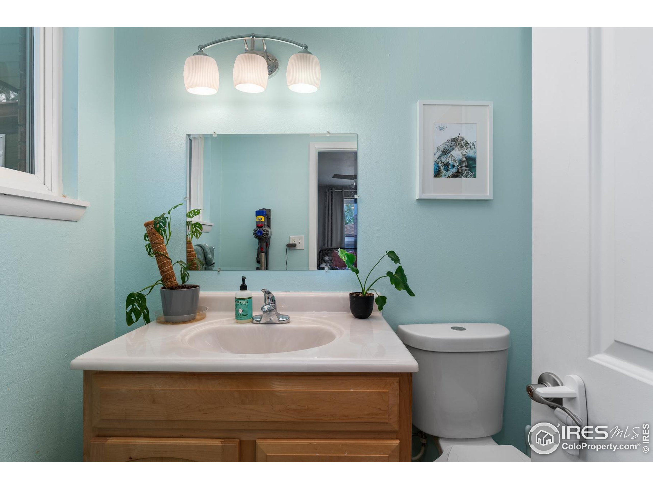 9261 Julian Way Westminster, CO 80031 - Photo 16 of 33 a bathroom with a sink a toilet and a mirror