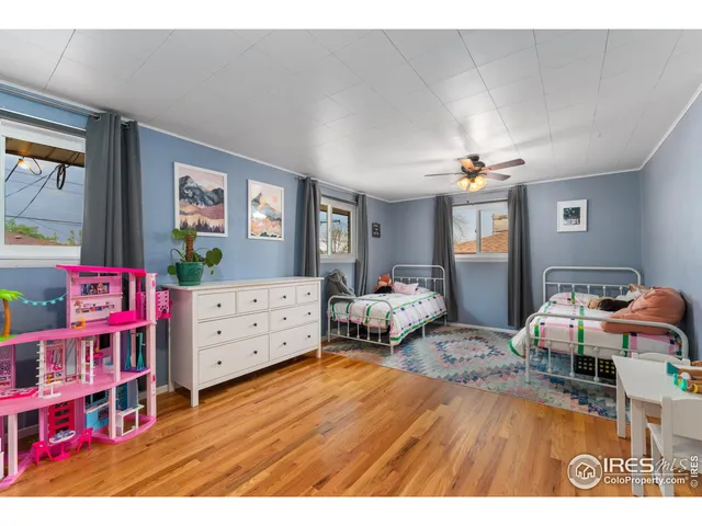 a bedroom with furniture and a wooden floor