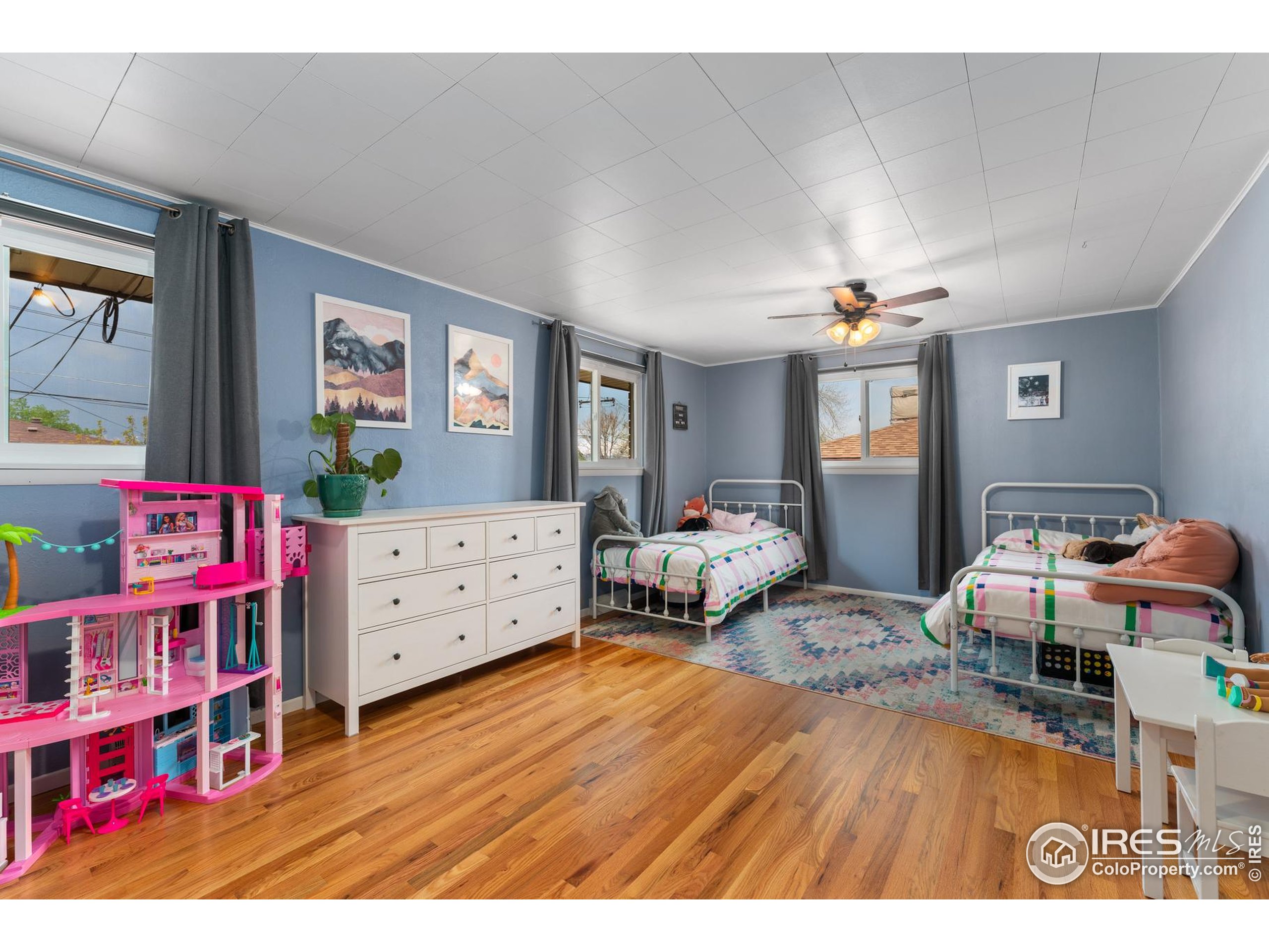 9261 Julian Way Westminster, CO 80031 - Photo 17 of 33 a bedroom with furniture and a wooden floor