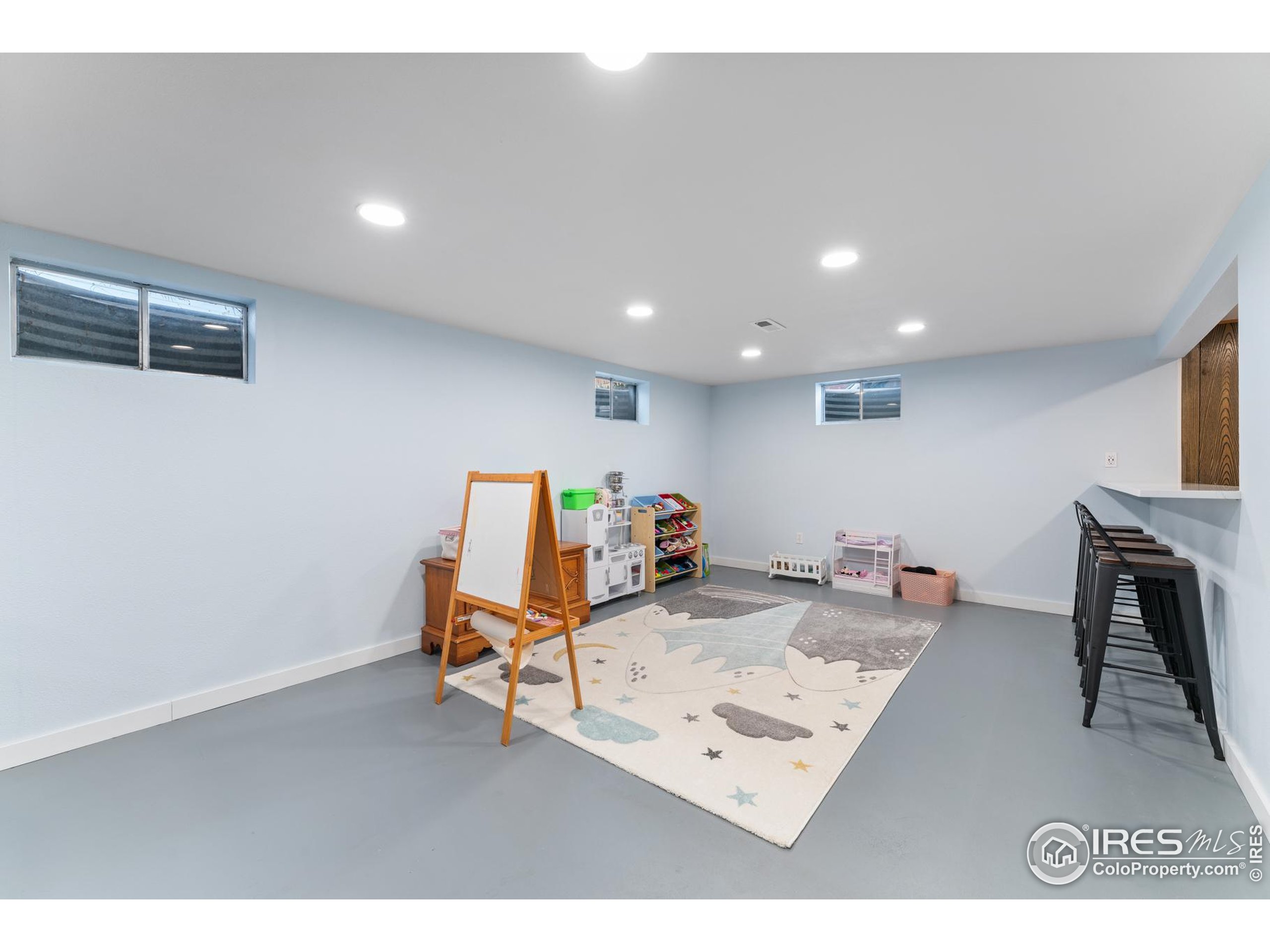 9261 Julian Way Westminster, CO 80031 - Photo 22 of 33 a living room with furniture and a flat screen tv