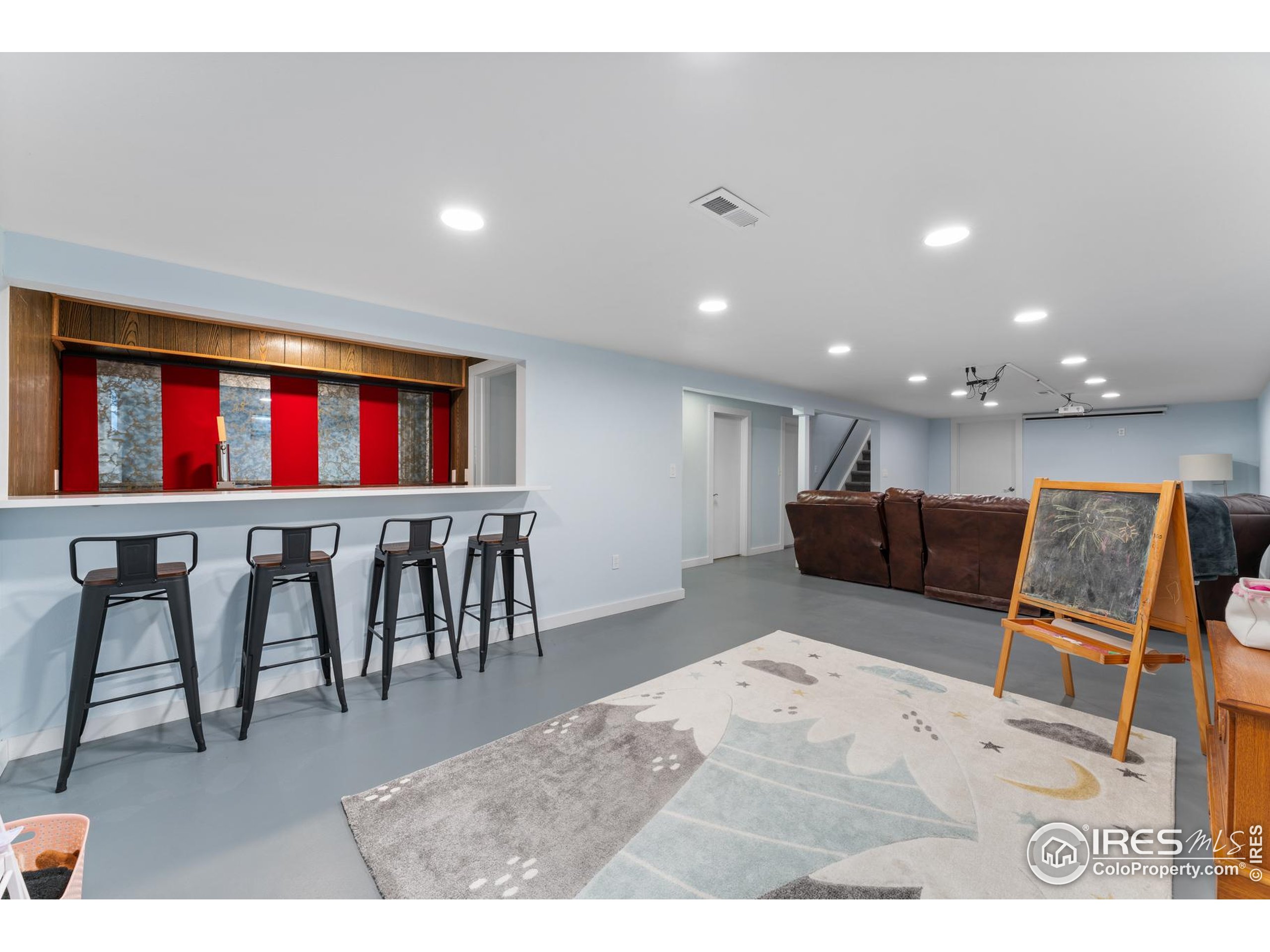 9261 Julian Way Westminster, CO 80031 - Photo 23 of 33 a living room with stainless steel appliances furniture a rug and a kitchen view