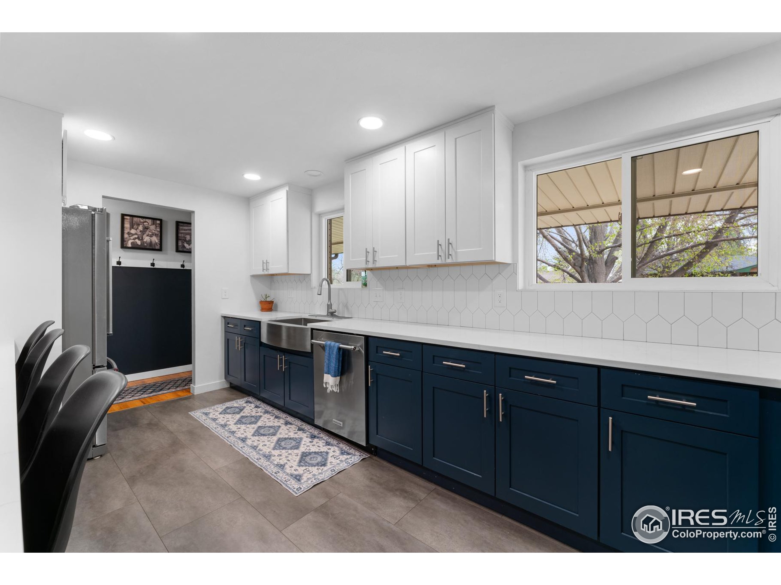 9261 Julian Way Westminster, CO 80031 - Photo 7 of 33 a kitchen with stainless steel appliances granite countertop a refrigerator a sink dishwasher and wooden cabinets with wooden floor