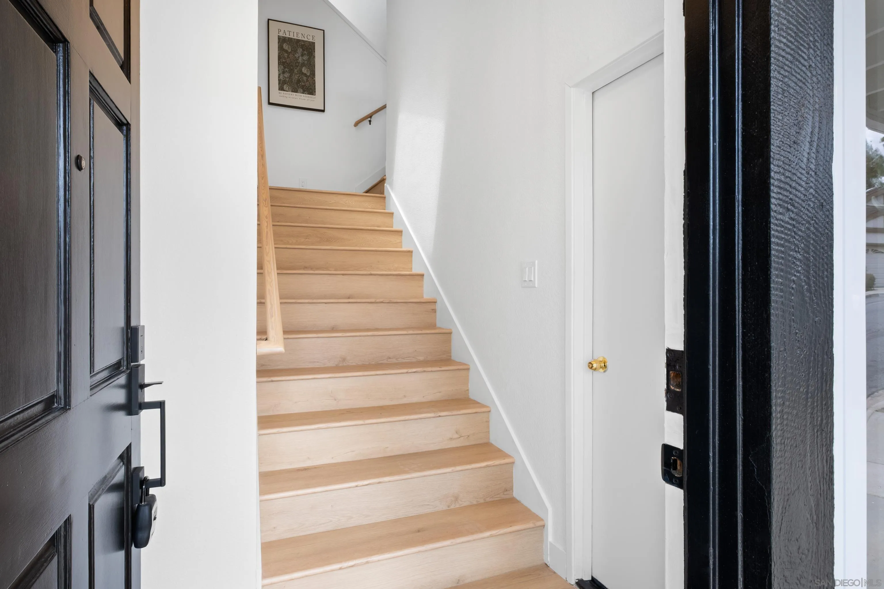 11478 Madera Rosa Way San Diego, CA 92124 - Photo 4 of 54 a view of a hallway with wooden floor and entryway