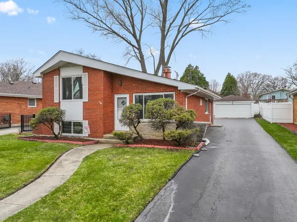 a front view of a house with a yard and porch
