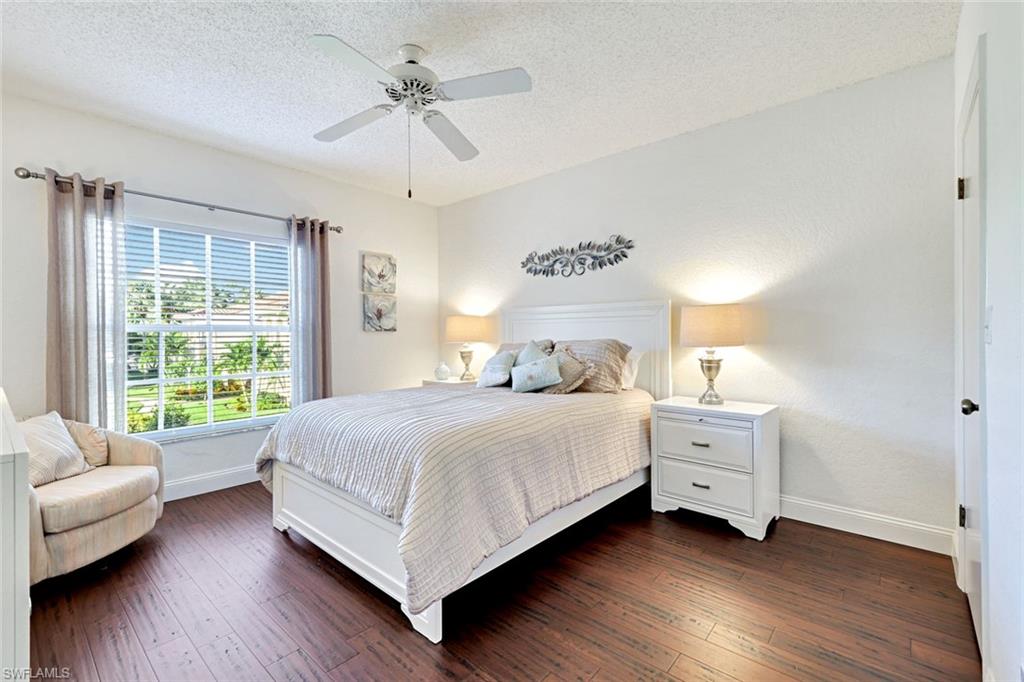 109 Tuscana Court, Unit 308 Naples, FL 34119 - Photo 11 of 18 a bedroom with a bed and a couch