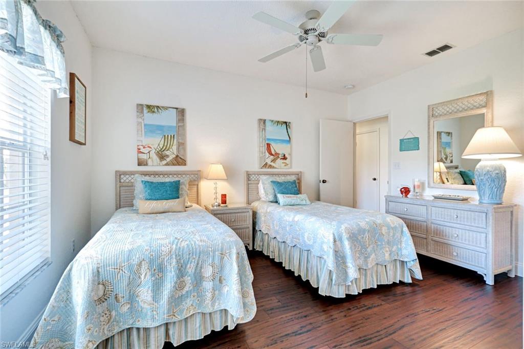 109 Tuscana Court, Unit 308 Naples, FL 34119 - Photo 12 of 18 a bedroom with two beds and lamps
