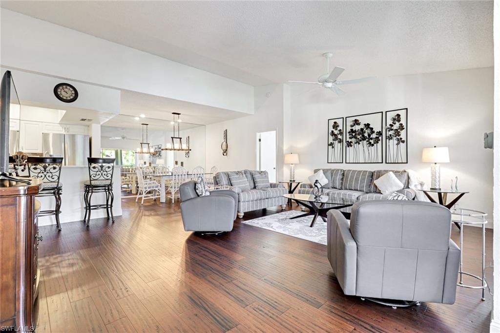 109 Tuscana Court, Unit 308 Naples, FL 34119 - Photo 3 of 18 a living room with furniture and wooden floor