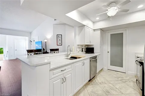 a kitchen with a sink and a stove top oven