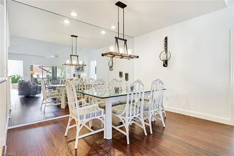 a view of a dining room with furniture wooden floor and chandelier