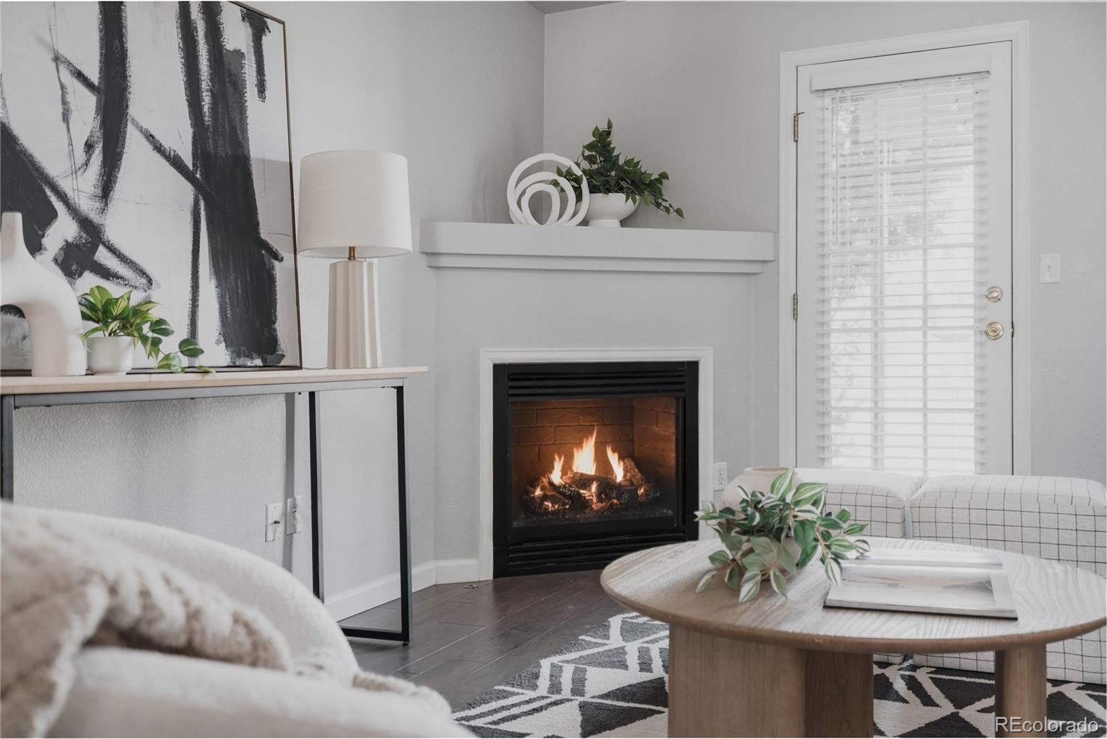 5081 Garrison Street, Unit 9 Wheat Ridge, CO 80033 - Photo 11 of 31 a living room with furniture and a fireplace
