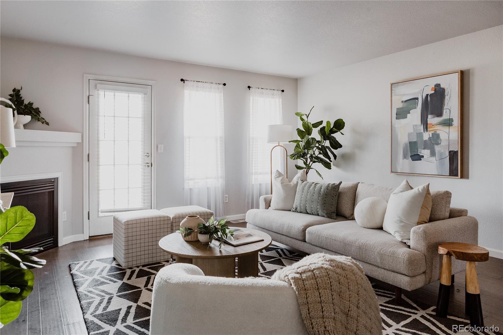 5081 Garrison Street, Unit 9 Wheat Ridge, CO 80033 - Photo 13 of 31 a living room with furniture and a potted plant