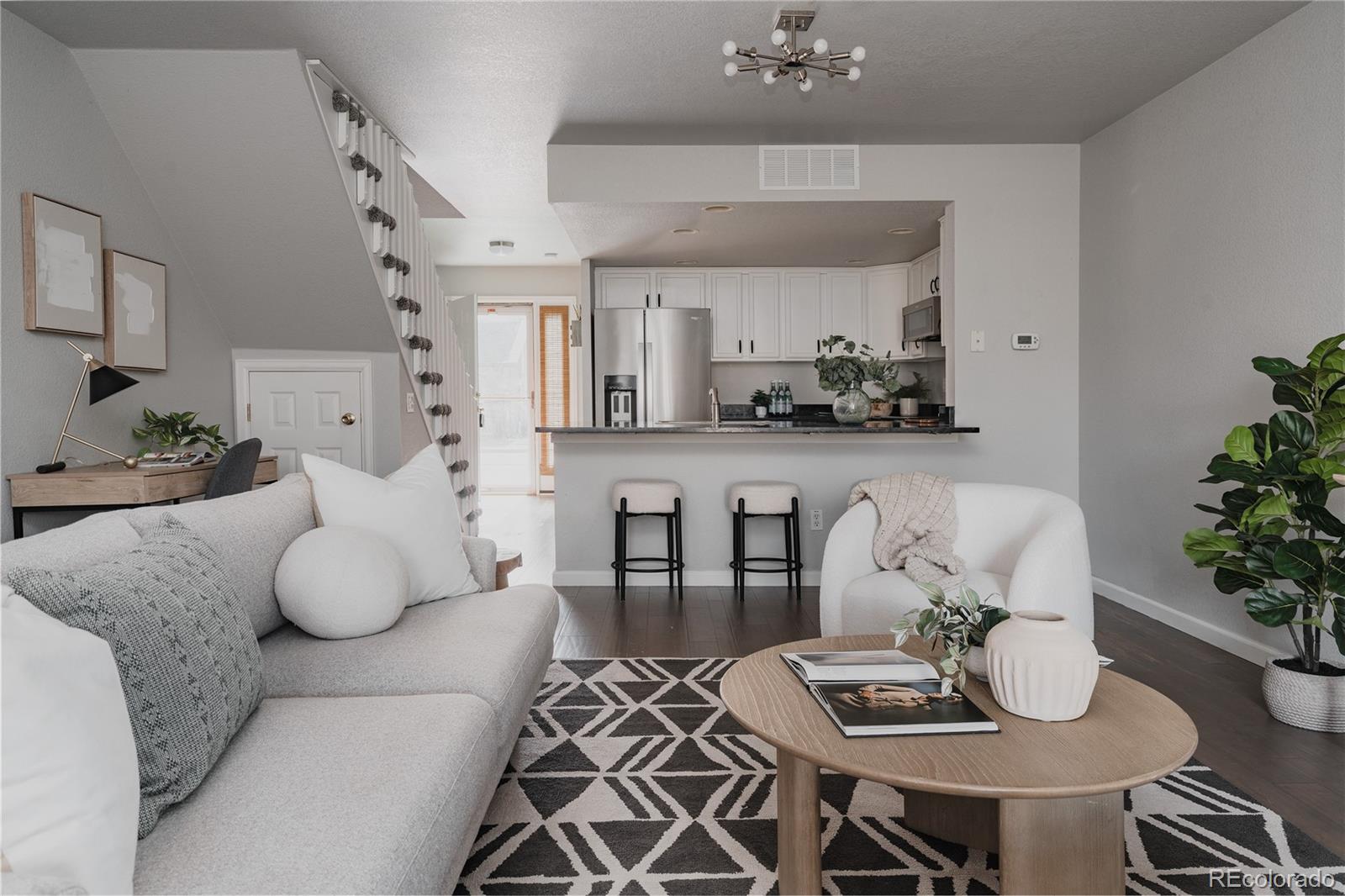 5081 Garrison Street, Unit 9 Wheat Ridge, CO 80033 - Photo 14 of 31 a living room with furniture and flowers