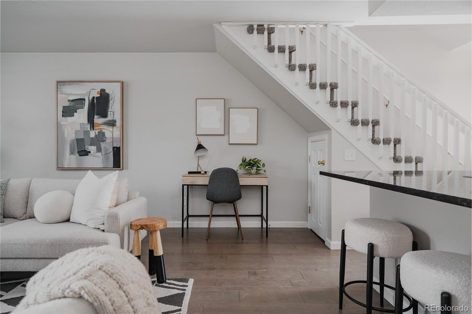 5081 Garrison Street, Unit 9 Wheat Ridge, CO 80033 - Photo 15 of 31 a living room with furniture and wooden floor